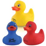 Three rubber bath ducks in yellow, blue, and red colors, featuring promotional logos on the blue and red ducks.