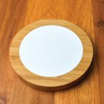 A Bamboo Ranger Fast Wireless Charger featuring a bamboo base and a smooth white charging surface.