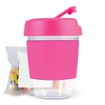 A pink reusable coffee cup with a clear base and a lid, accompanied by a bag of colorful jelly beans.