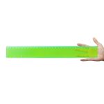 A transparent green 30cm ruler held in a hand, featuring both metric and imperial measurements.