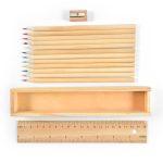 A wooden box containing a set of colored pencils in various colors, with a sharpener and a wooden ruler.
