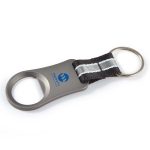 A drink bottle opener in silver metal with a black fabric handle and a ring for keychain attachment.