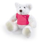 A white plush teddy bear wearing a pink shirt, sitting with its legs outstretched. The bear has round ears and a brown nose.