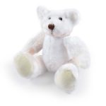 A soft, white plush teddy bear with pale yellow accents sitting with its arms and legs spread out.