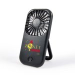 A portable black fan with a stand and a logo on the front, designed for leisure and outdoor use.