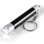 A compact flashlight featuring a sleek black body with silver accents and a keychain attachment for portability.