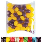 A pillow pack filled with yellow and purple jelly beans, featuring a variety of colors in the background.