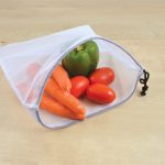 A drawstring bag in white mesh containing carrots, cherry tomatoes, and a green bell pepper. Features a black drawstring.