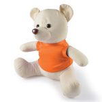 A plush bear in a light cream color with a brown nose, wearing an orange shirt. It has a friendly expression and is seated.