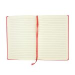 An open Genesis A5 notebook with lined pages and a red cover, featuring a red ribbon marker.