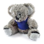 A plush toy koala with a soft, fuzzy texture, wearing a blue shirt.