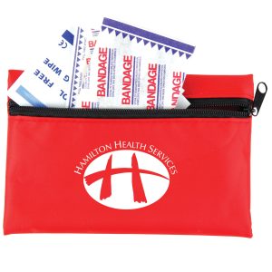 A red first aid kit containing bandages, with a zipper closure and a logo on the front.