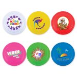 A set of colorful frisbees in white, yellow, red, blue, and green, each featuring different logos and designs.