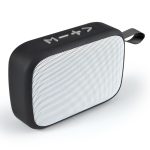 A rectangular black and white portable speaker with a textured surface and a carrying strap.