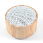 A bamboo Bluetooth speaker featuring a circular design with a perforated upper surface.