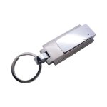 A metallic silver flash drive shaped like a keychain, featuring a shiny clip and a keyring attachment.