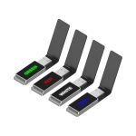 A set of four Milan LED flash drives in green, red, white, and blue, featuring a sleek black design and branding.