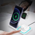 A white 3-in-1 wireless charger for a phone, smartwatch, and earbuds, featuring a green charging indicator.
