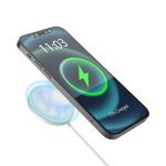 A wireless phone charger in a circular design emits a blue glow, placing emphasis on a phone displaying a charging icon.