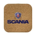 A square cork wireless charger with a logo printed in blue and red, featuring a lion design and the word "SCANIA".