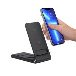 A black wireless charger with a phone being placed on it. The charger features a stand and has a logo.
