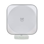 A magnetically-designed, square-shaped wireless car charger in a light grey finish, featuring a simple logo.