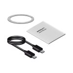 A power bank with a metallic ring, a user manual, and a black USB-C charging cable.