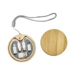 A round wooden kit containing multiple charging cables in grey, featuring a secure loop for easy carrying.