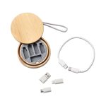 A bamboo charging cable kit containing a white charging cable and multiple connectors in a circular case.