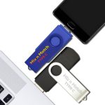 A blue, grey, and silver Mix N Match Type-C flash drive arranged near a smartphone and laptop. Each flash drive has a logo.