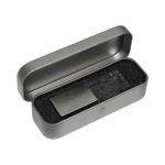 A 3D crystal flash drive in a grey metal case, resting on black foam padding. The case is open.