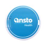 A round blue flash drive with a white casing and a logo. It has a simple, compact design.