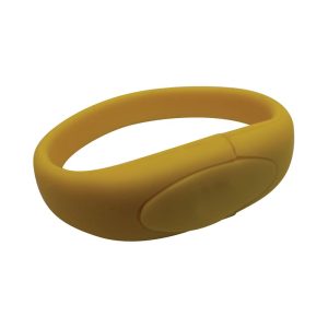 A yellow silicone wristband with a smooth surface and an oval button-like feature. It has a minimalistic design.