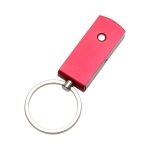 A red Triton flash drive with a keyring attachment and a silver circular keychain.