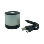 A silver Bluetooth speaker with a black base, accompanied by a USB charging cable.