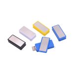 A collection of Revati flash drives in black, white, blue, yellow, and silver. Each has a shiny metallic surface and a USB connector.