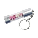 A silver storage LED USB drive in a transparent casing, featuring decorative pink and white shapes, attached to a keychain.