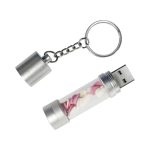 A silver LED USB flash drive with a clear container holding pink and white decorative elements, attached to a keychain.