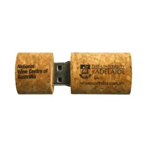 A cork flash drive in natural cork colour, featuring a logo and text on its surface.