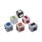 A collection of six fidget cubes in white, black, and various bright colours, featuring different tactile buttons and switches.