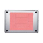 A slim laptop stand in coral pink with a textured surface and black accents. Features a logo on the base.