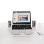 A foldable laptop stand in white, supporting a laptop and two smartphones, featuring a sleek design.