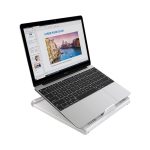 A foldable laptop stand in silver, supporting a laptop displaying a presentation on a white background.