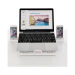 A foldable laptop stand in white, supporting a laptop and two smartphones. The setup includes a subtle logo on the stand.