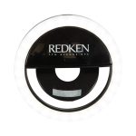 A round, black LED selfie light with outer white lights and a central circular opening. It features a logo.
