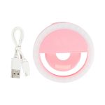 A pink LED selfie light with a circular design and a USB charging cable.