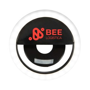 A round black LED selfie light with a glowing white rim and a logo in the centre.