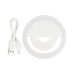 A white circular LED selfie light with a USB charging cable. The light features a ring design for illumination.