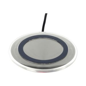 A round silver wireless charger with a black ring around the centre and a connected cable.