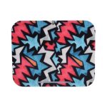 A wireless charger stand featuring a vibrant, abstract pattern with black, pink, blue, and white colours.